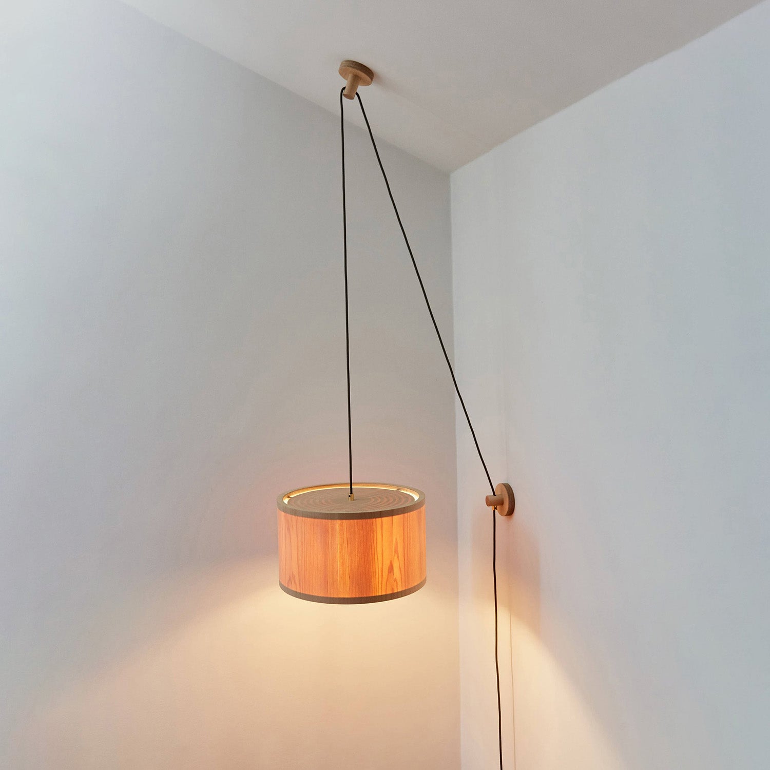 Lozi's plywood and translucent wood veneer Round Lamp wall and ceiling mounted, turned on in a bright room