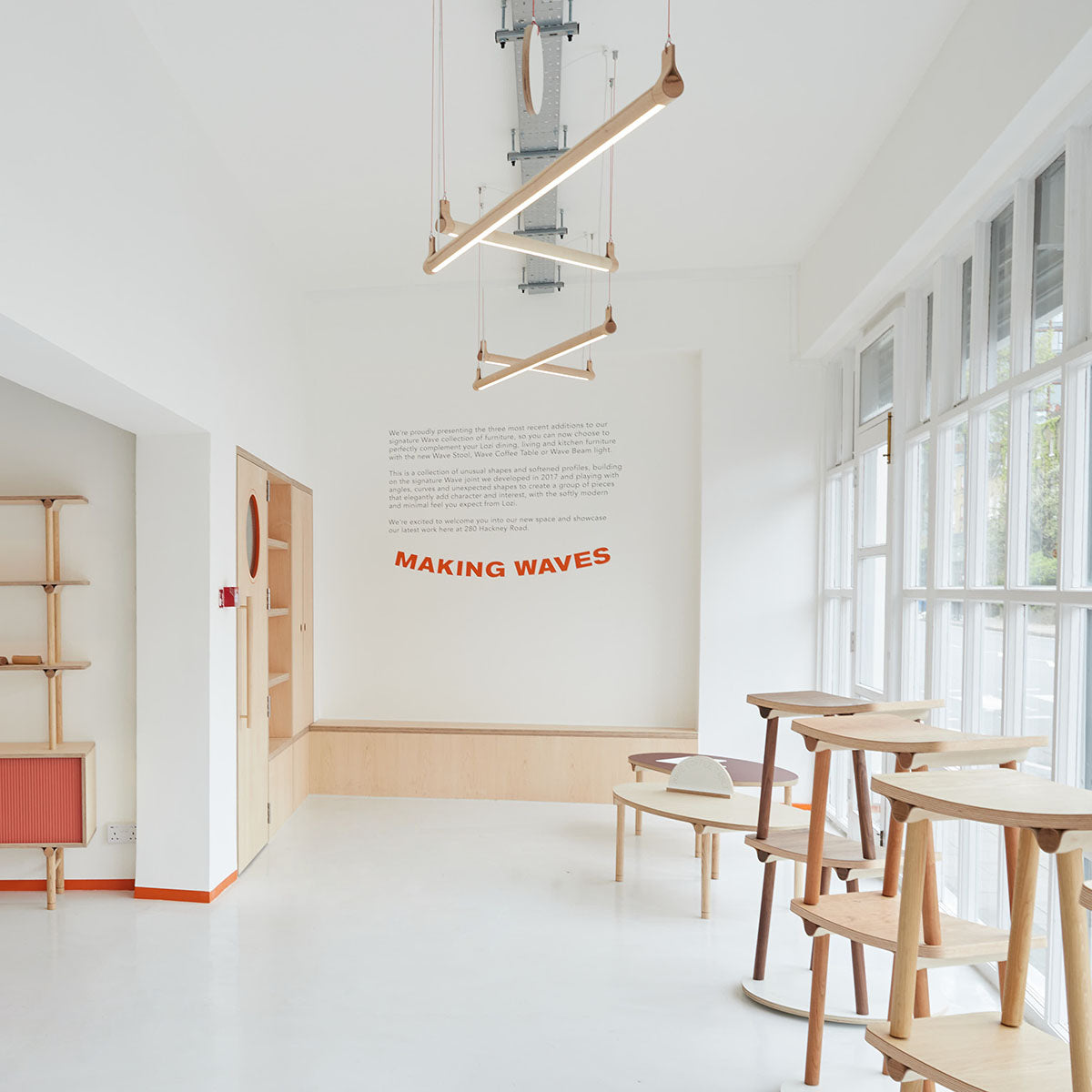 Lozi's showroom at the launch of the Making Waves collection with four Wave Beam lamps hanging from the ceiling